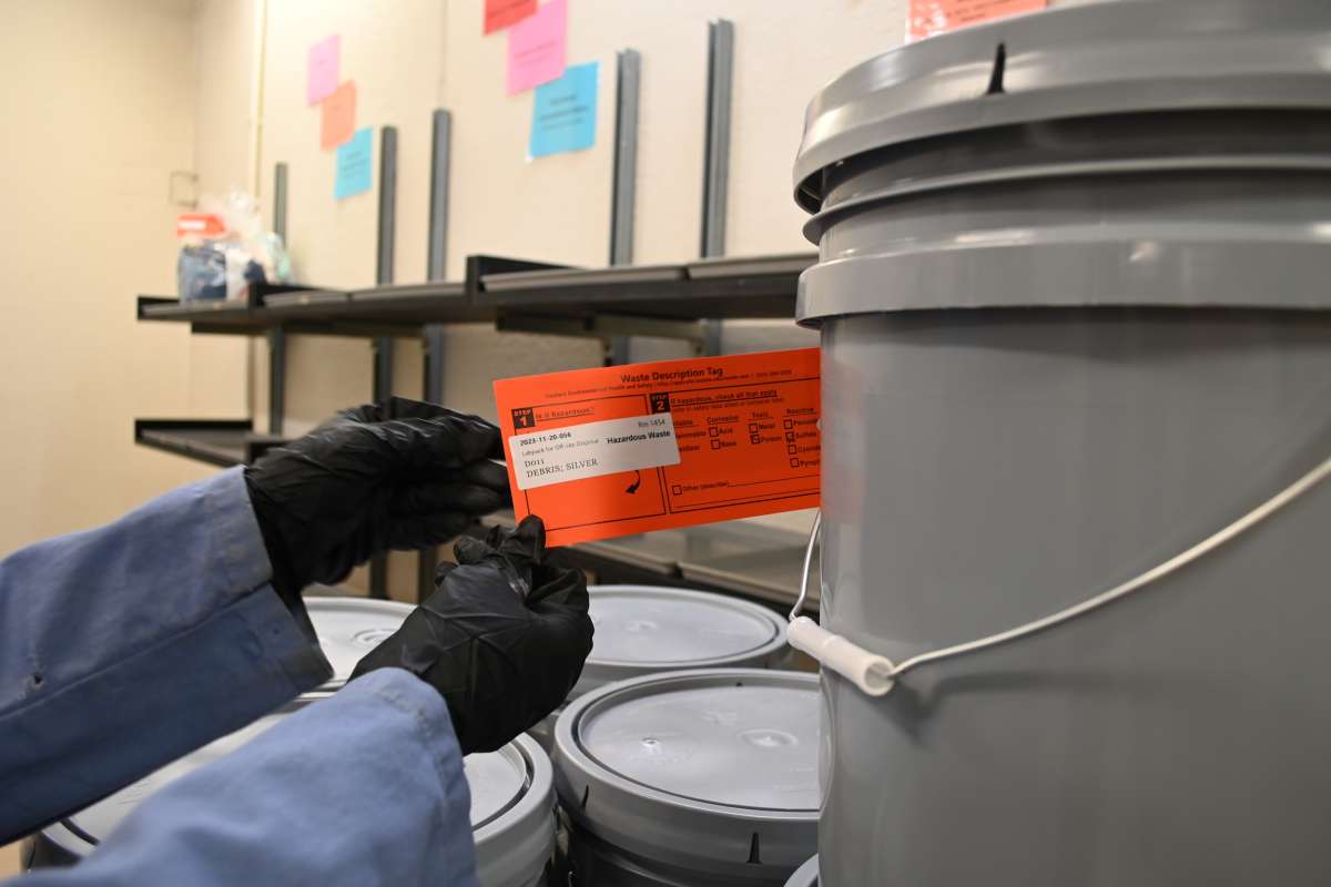 Example of the orange hazardous waste tag that must be filled out and attached to each waste container.