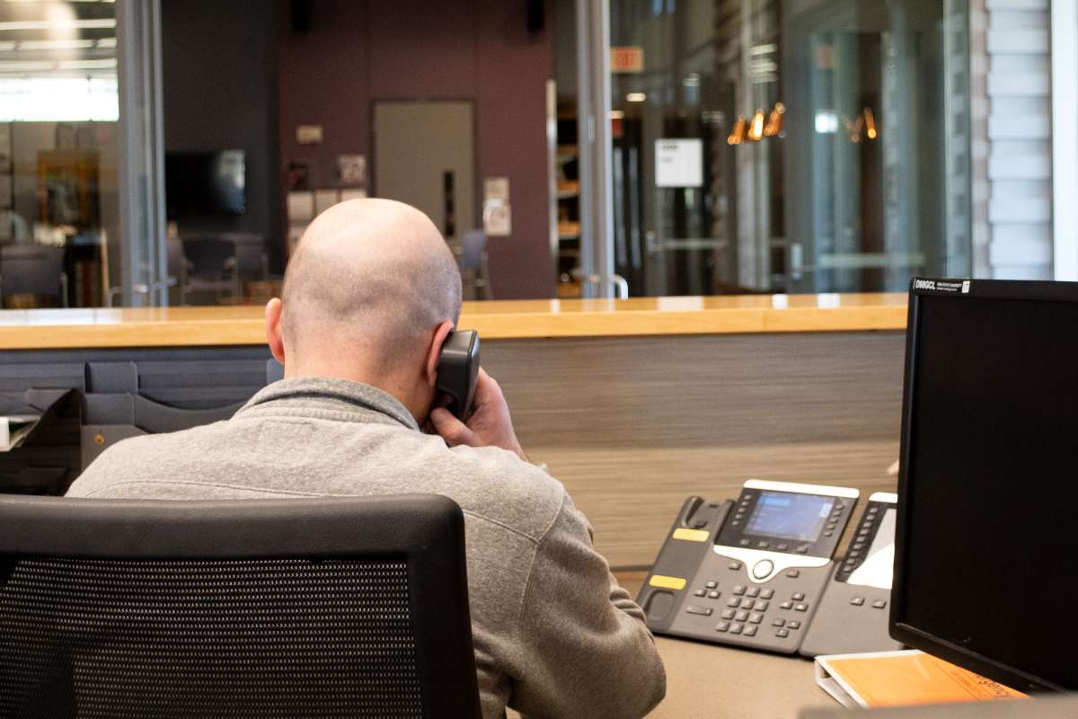 EH&S employee answers the phone at the reception desk
