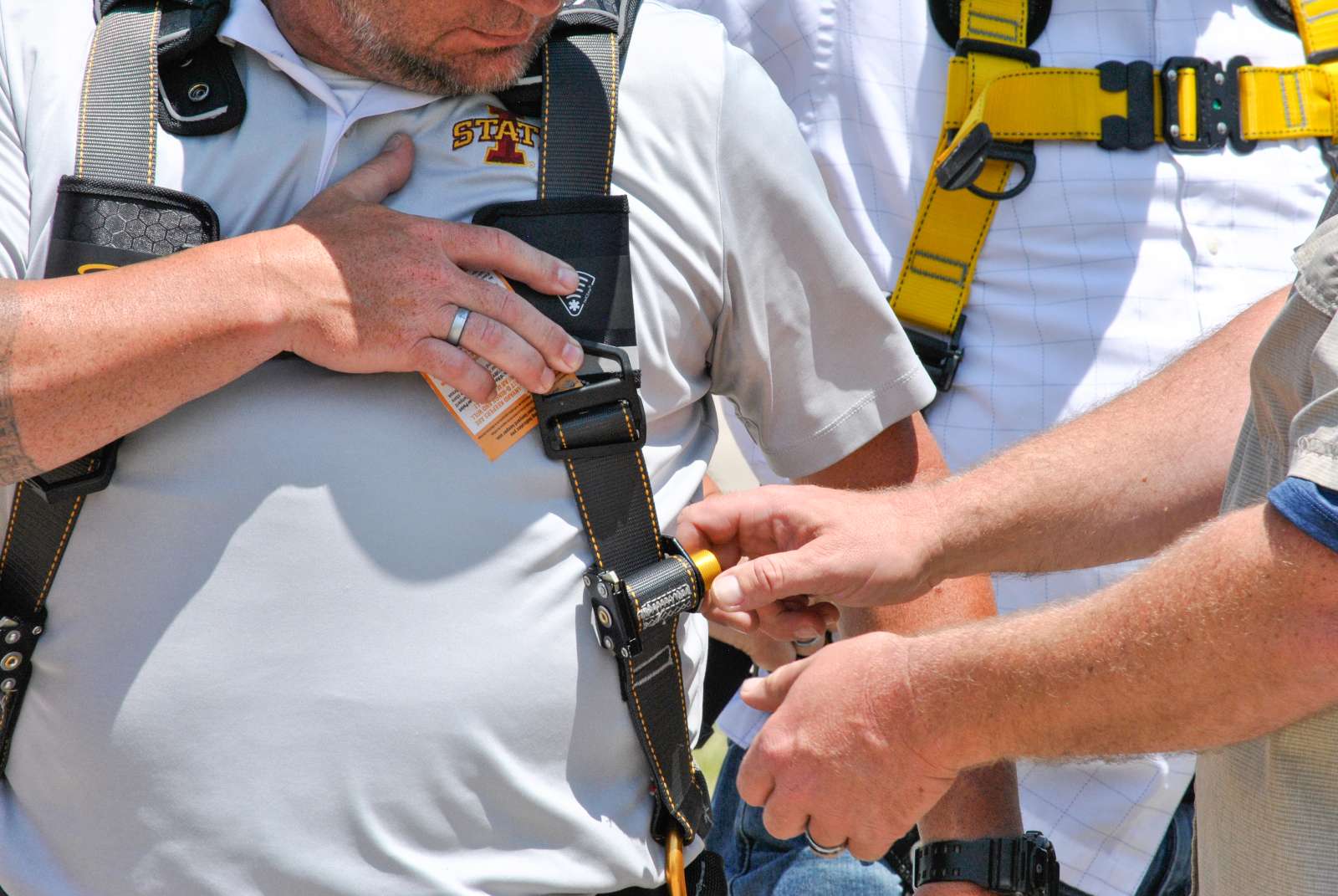 Course instructor demonstrates how to adjust a fall protection body harness.
