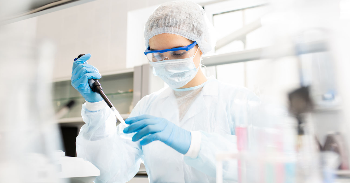 Researcher using pipette in laboratory