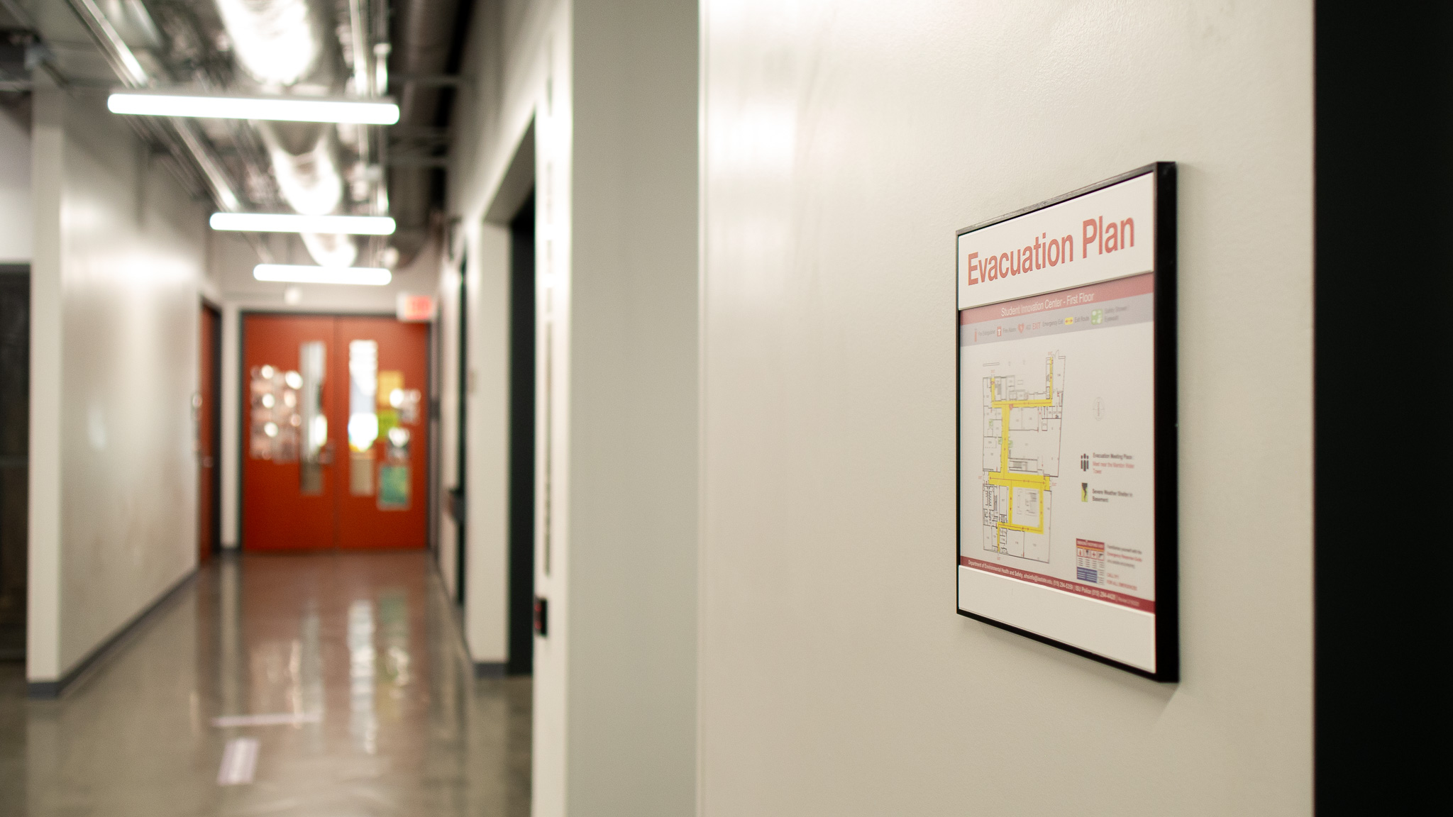 Photo of an emergency evacuation route map posted in a hallway in the Student Innovation Center.