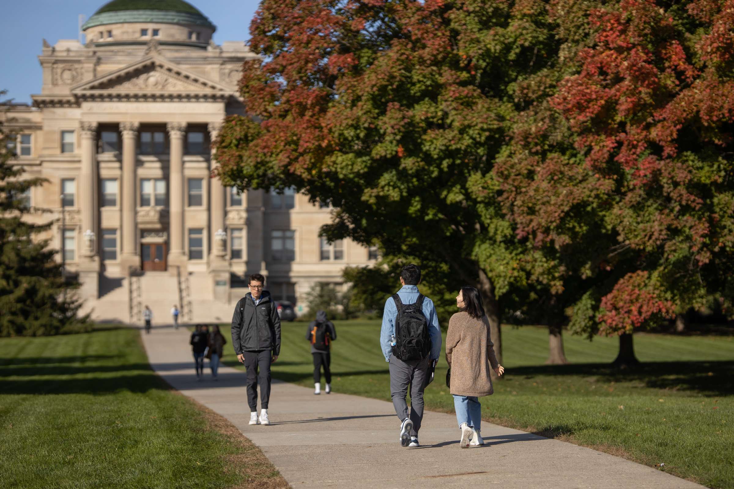 People walking across central campus during fall