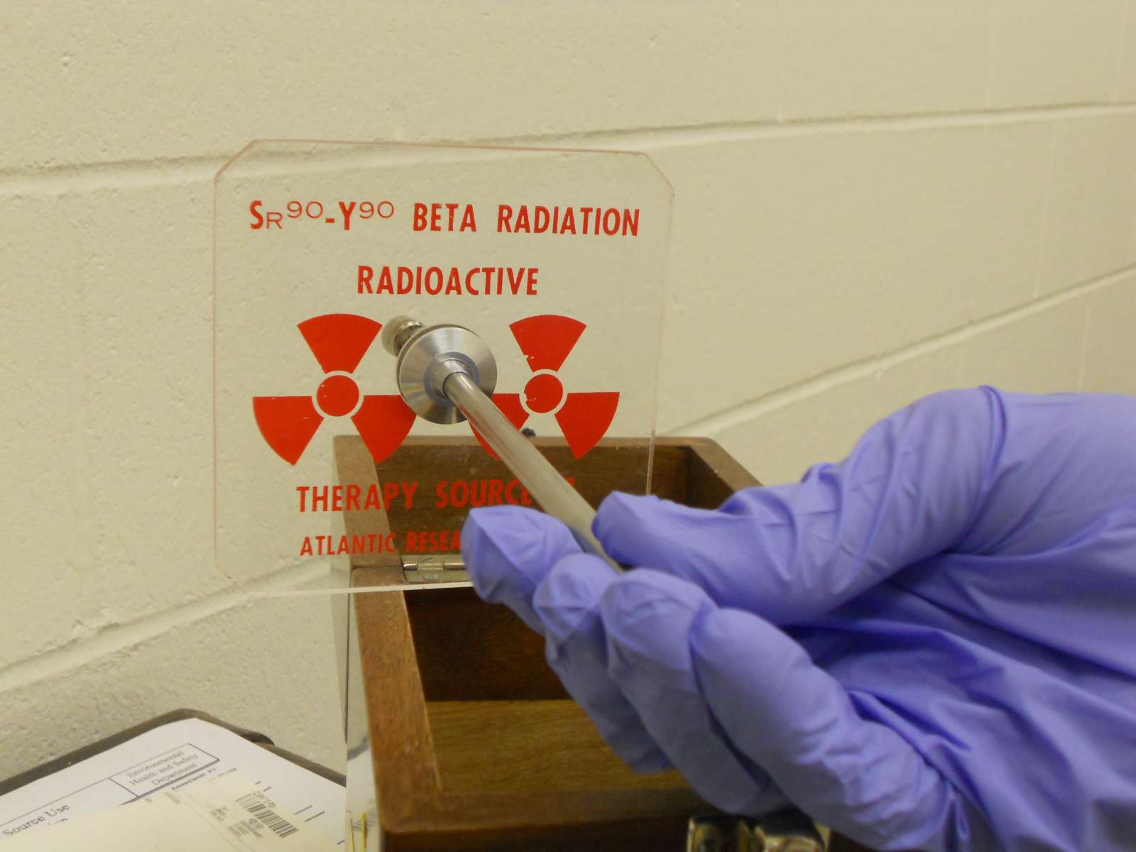 Photo of someone holding a sample of a radioactive material