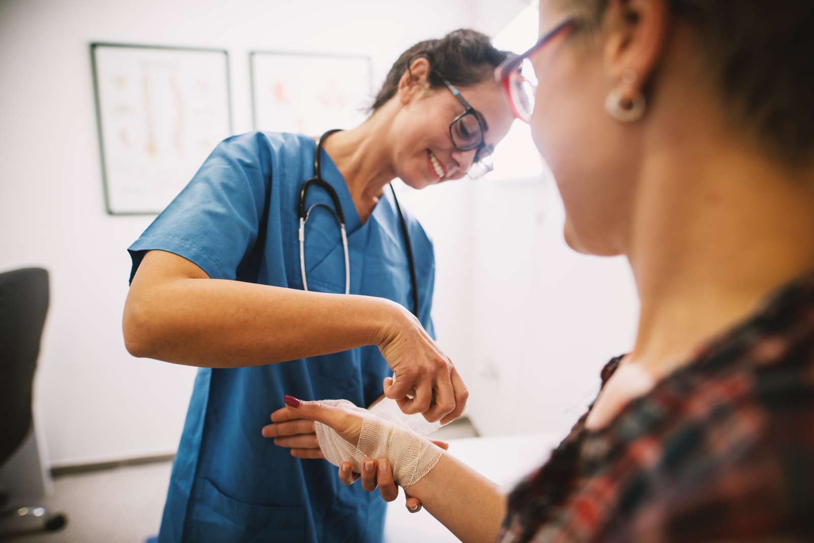 Nurse wraps bandage around patient's wrist